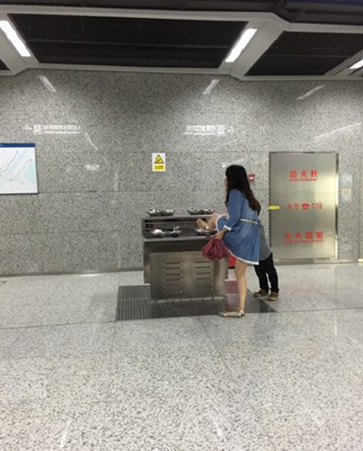 一女子在地铁直饮水机上洗脚